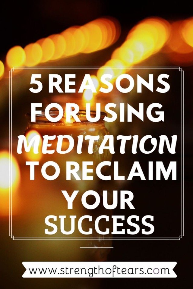 A line of lit candles are in a dark room to encourage an atmosphere for meditation